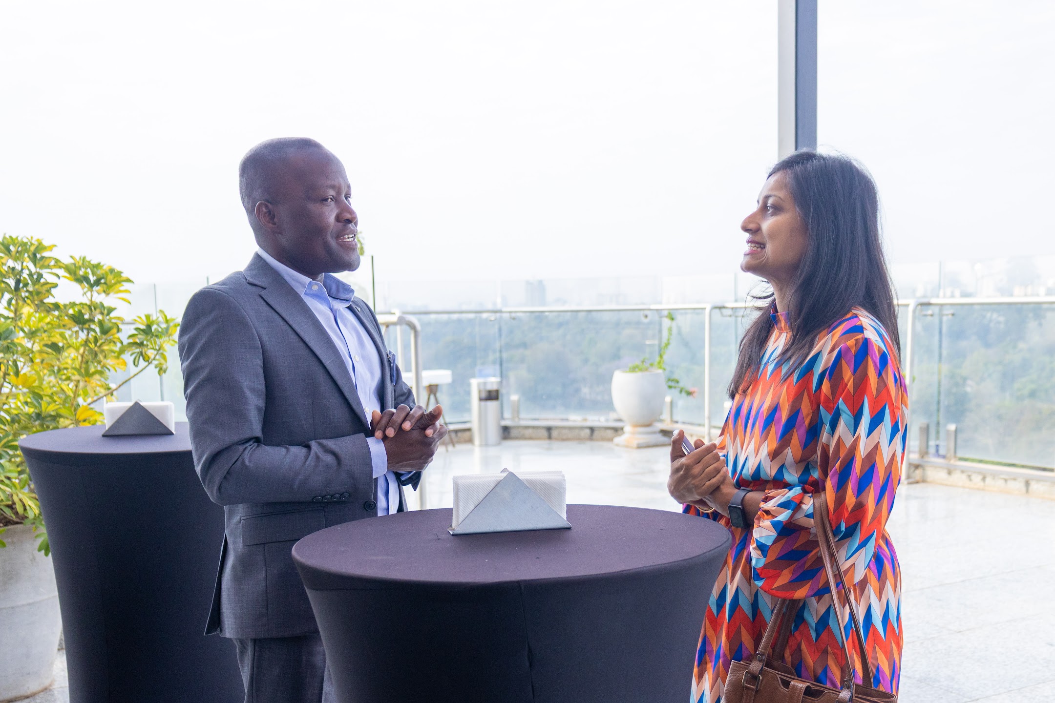 Two business guests talking on a rooftop