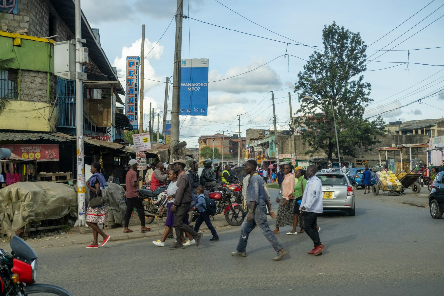 People walking through a lively Nairobi street